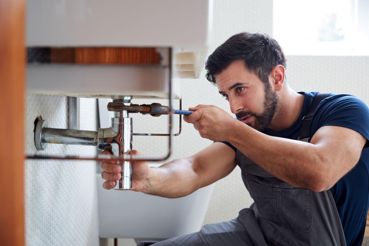 man performing Plumbing Service